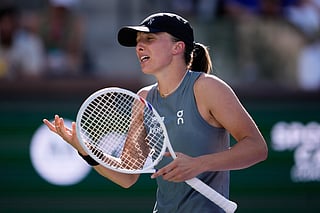 Iga Swiatek, of Poland, reacts after losing a point against Elina Svitolina, of Ukraine, during a quarterfinal match at the BNP Paribas Open tennis tournament, Thursday, March 12, 2026, in Indian Wells, Calif.