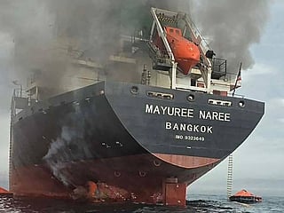This handout photo taken on March 11, 2026 shows smoke rising from the Thai bulk carrier 'Mayuree Naree' near the Strait of Hormuz after an attack. 