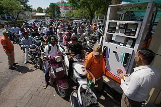 Motorists queue up to get fuel at a pump, fearing a possible fuel shortage due to the US Iran war, in Ahmedabad, India, Monday, March 23, 2026. 