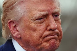 President Donald Trump speaks with reporters before departing on Marine One from the South Lawn of the White House, Friday, March 20, 2026, in Washington.