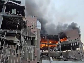 This video grab taken from undated UGC images posted on social media on March 23, 2026, shows destruction and fire at the Iranian ministry of defence's electronics industries building in Tehran following a strike. 