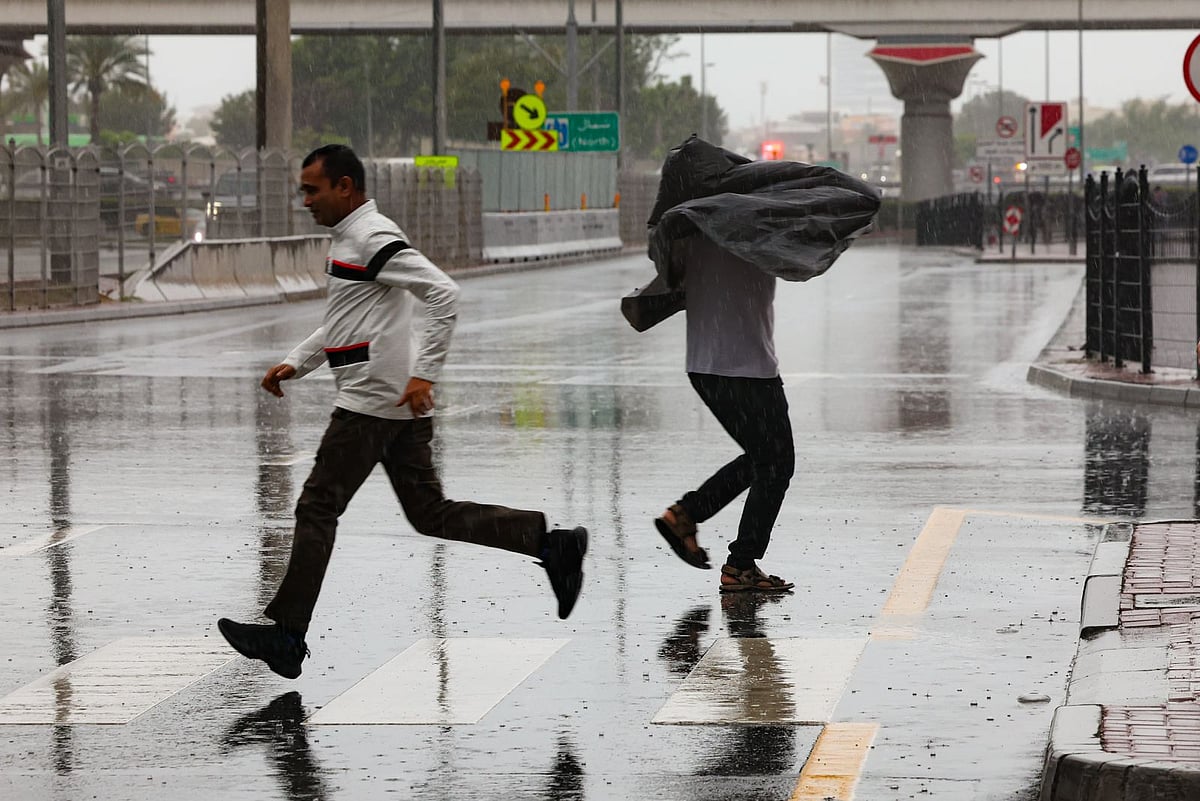 Residents brave the rain at Business Bay in Dubai on Monday. 