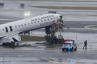 An Air Canada Express CRJ-900 sits on the runway after colliding with a Port Authority fire truck at LaGuardia Airport in New York, on March 23, 2026.