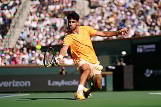 Carlos Alcaraz, of Spain, returns a shot against Daniil Medvedev, of Russia, during a semifinal match at the BNP Paribas Open tennis tournament, Saturday, March 14, 2026, in Indian Wells, Calif. (AP Photo/Mark J. Terrill)
