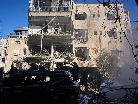 Israeli security forces and rescue team respond at the site of an Iranian missile strike in Tel Aviv, Israel.