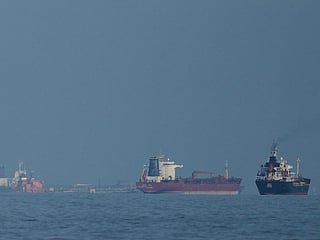 Oil tankers and cargo ships line up in the Strait of Hormuz.