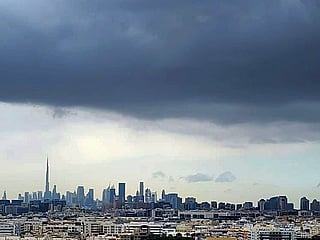 A blanket of dark clouds covers Dubai’s skyline