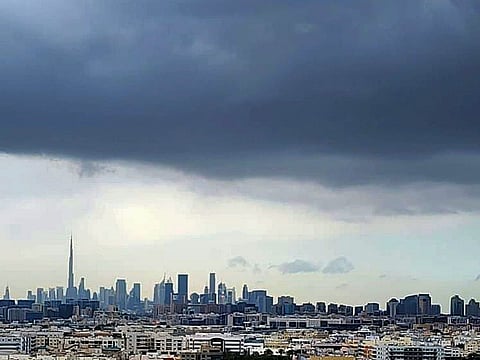 A blanket of dark clouds covers Dubai’s skyline