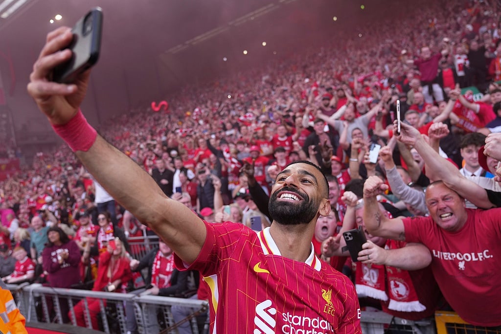 Liverpool's Mohamed Salah celebrates by taking a selfie with the Liverpool fans