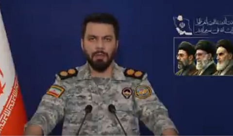 An Iranian military spokesperson with portraits of the late Khamenei and present supreme leader and his son Mojtaba Khamenei in the background — as hardline forces shape Tehran’s stance on US peace efforts.