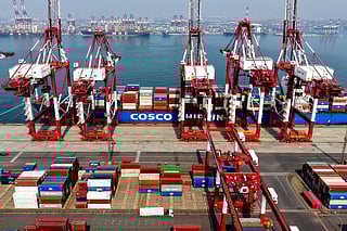 A cargo ship operated by Cosco Shipping is docked at the foreign trade container terminal of Qingdao Port, operated by Shandong Port Group, in China's eastern Shandong province on March 25, 2026.