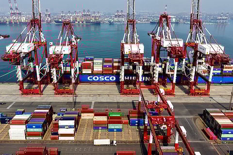A cargo ship operated by Cosco Shipping is docked at the foreign trade container terminal of Qingdao Port, operated by Shandong Port Group, in China's eastern Shandong province on March 25, 2026.