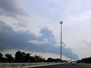 Smoke rises from the area of the Kuwait International Airport after a reported drone strike hit a fuel depot. 