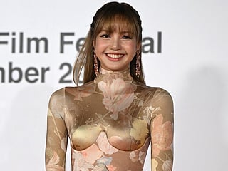 Thai rapper and singer Lisa, a member of the K-pop group Blackpink, arrives on the red carpet during the opening ceremony of the 30th Busan International Film Festival (BIFF) at the Busan Cinema Center in Busan on September 17, 2025.