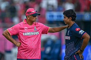 Rajasthan Royals' Indian cricket player Vaibhav Suryavanshi (R) speaks with the team's head coach Rahul Dravid before the start of the Indian Premier League (IPL) Twenty20 match between Rajasthan Royals and Mumbai Indians at the Sawai Mansingh Stadium in Jaipur on May 1, 2025.