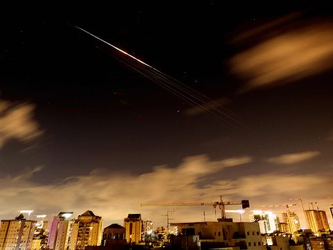 Rocket trails are seen in the sky amid a fresh barrage of Iranian missile attacks above the Israeli coastal city of Netanya on March 27, 2026. 