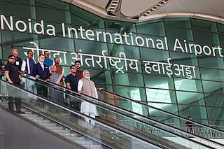 This handout photograph taken on March 28, 2026 and released by the Indian Press Information Bureau (PIB) shows Prime Minister Narendra Modi (C) riding an escalator after the inauguration of the Noida International Airport in Jewar, Uttar Pradesh state.
