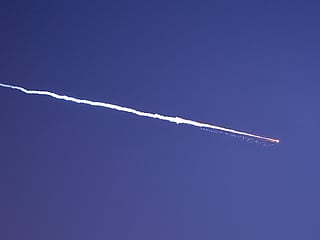 Rocket trails are seen in the sky above the Israeli coastal city of Netanya amid a fresh barrage of Iranian missile attacks on March 28, 2026. 