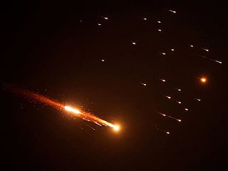 Rocket trails are seen in the sky above the Israeli coastal city of Netanya, amid a barrage of Iranian missile. 