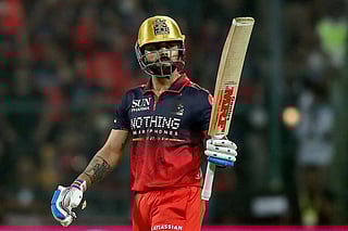 Royal Challengers Bengaluru's Indian cricket player Virat Kohli celebrates after scoring a half-century (50 runs) during the 2026 Indian Premier League (IPL) T20 match between Royal Challengers Bengaluru and Sunrisers Hyderabad at the M Chinnaswamy Stadium in Bengaluru on March 28, 2026.