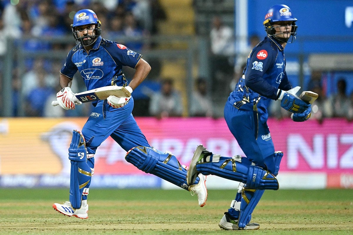 Mumbai Indians' Indian cricket player Rohit Sharma (L) and teammate South Africa's Ryan Rickelton R) run between the wickets during the 2026 Indian Premier League (IPL) T20 match between Mumbai Indians and Kolkata Knight Riders at the Wankhede Stadium in Mumbai on March 29, 2026.
