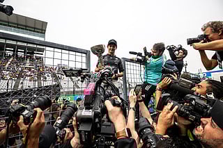 Mercedes' Italian driver Kimi Antonelli holds the trophy during a celebration with his team after winning the Formula One Japanese Grand Prix at the Suzuka circuit in Suzuka, Mie prefecture on March 29, 2026.