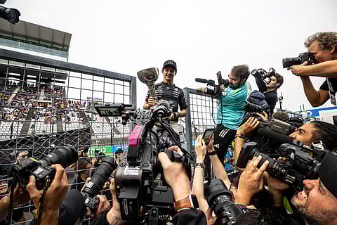 Mercedes' Italian driver Kimi Antonelli holds the trophy during a celebration with his team after winning the Formula One Japanese Grand Prix at the Suzuka circuit in Suzuka, Mie prefecture on March 29, 2026.