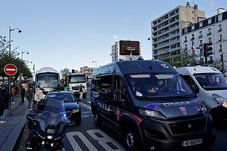 A photo shows parked buses and trucks near police vehicles ahead of a demonstration by lorry and coach drivers to block the city's Boulevard Peripherique ring road, in eastern Paris, on March 30, 2026.