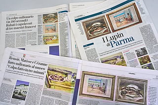 Italian Newspapers carry the news of the heist of three paintings, "Fish" by Auguste Renoir, "Still Life with Cherries" by Paul Cézanne, and "Odalisque on the Terrace" by Henri Matisse, from a museum near Parma, northern Italy, Monday, March 30, 2026. (AP Photo/Domenico Stinellis)