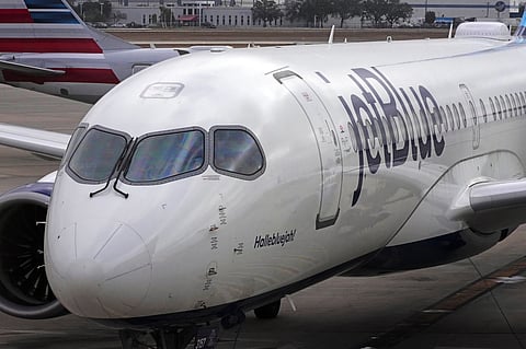 FILE - A Jet Blue Airlines jet pushes back from a gate at the Pittsburgh International Airport in Imperial, Pa., Feb. 13, 2026. (AP Photo/Gene J. Puskar, File)