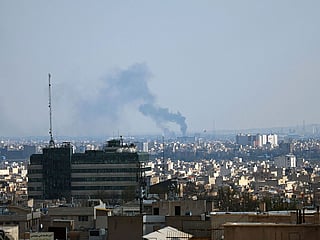 Smoke rises from the site of a strike in Tehran .