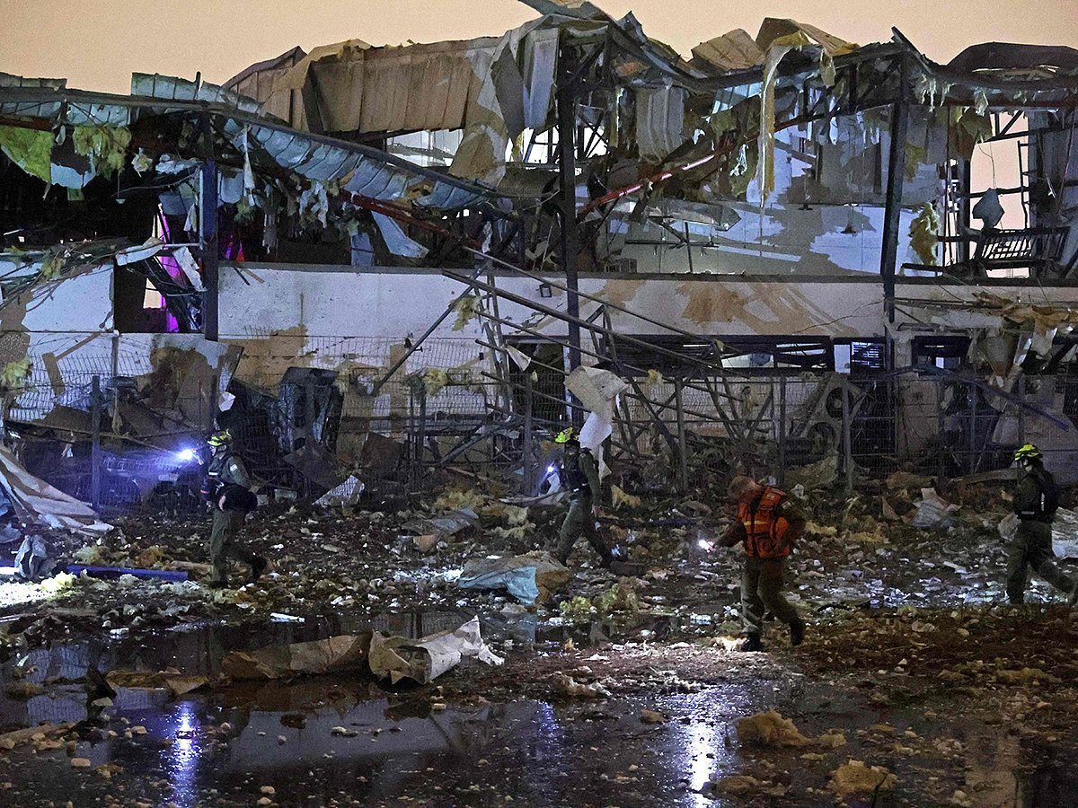 Israeli security forces and first responders inspect the site of an Iranian strike that hit a residential neighbourhood in Petah Tikva on April 2, 2026.