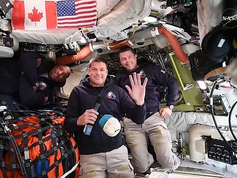 This screengrab from a NASA live broadcast video shows (L-R) NASA astronaut and Artemis II pilot Victor Glover, Canadian Space Agency astronaut Artemis II Mission Specialist Jeremy Hansen and NASA astronaut and Artemis II Commander Reid Wiseman during a press call as they travel to the Moon in the Orion spacecraft, on April 3, 2026.