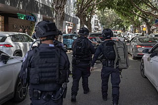 First responders look from the street at a building that was hit by an Iranian projectile attack in Ramat Gan in central Israel on April 6, 2026.