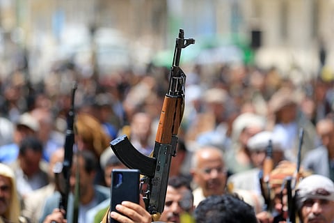 Supporters of the Iran-backed Houthi movement brandish their weapons as they rally in solidarity with Iran and Lebanon amid the US-Israeli war with Iran, in the capital Sanaa on April 6, 2026.