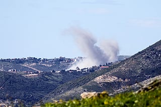 Smoke rises from a target inside Lebanon after an Israeli strike.