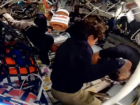 This screengrab from a NASA livestream shows a jar of Nutella floating aboard the Orion spacecraft as Artemis II crew members Victor Glover, Reid Wiseman, Jeremy Hansen and Christina Koch work on April 6, 2026.