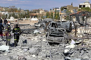 First-responders inspect destroyed vehicles and rubble and debris in the aftermath of Israeli bombardment on the village of Shmistar in the centre of Lebanon's eastern Bekaa valley on April 8, 2026.