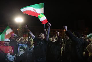 Iranians react after a ceasefire announcement at the Enqelab square, in Tehran, on April 8 2026.