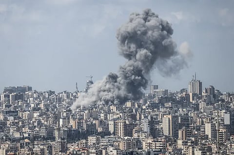 First responders and residents gather at the site of an Israeli airstrike in Beirut's Tallet al-Khayyat neighbourhood, on April 8, 2026.