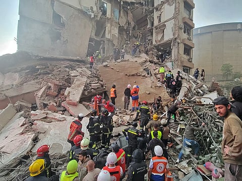 First responders and residents gather at the site of an Israeli airstrike in Beirut's Tallet al-Khayyat neighbourhood, on April 8, 2026.