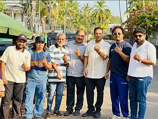 Nissar Thalangar (third from right) and members of KMCC who flew home to cast their votes in the Kerala Assembly Election 2026