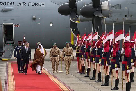 Britain's Prime Minister Keir Starmer (L) is welcomed at an airport at an undisclosed location in Bahrain on April 9, 2026.