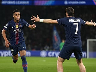 PSG's Desire Doue, left, celebrates with PSG's Khvicha Kvaratskhelia after scoring the opening goal during the Champions League quarterfinal first leg soccer match between Paris Saint-Germain and Liverpool in Paris, Wednesday, April 8, 2026. (AP Photo/Thibault Camus)