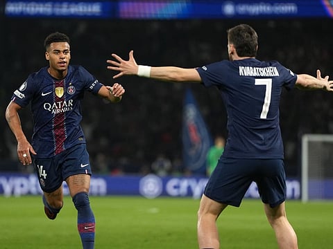PSG's Desire Doue, left, celebrates with PSG's Khvicha Kvaratskhelia after scoring the opening goal during the Champions League quarterfinal first leg soccer match between Paris Saint-Germain and Liverpool in Paris, Wednesday, April 8, 2026. (AP Photo/Thibault Camus)