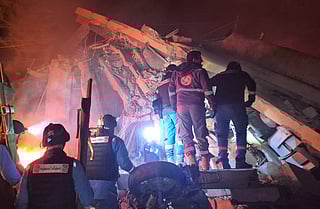 First responders search under the rubble at the site of an Israeli airstrike in the village of Habbouch, southern Lebanon on April 10, 2026.
