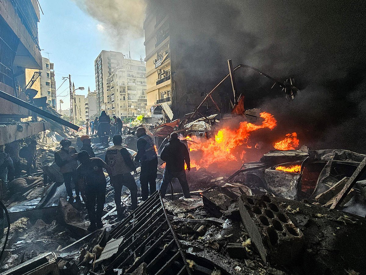 First responders stand amid rubble at the site of an Israeli airstrike in Beirut's Corniche Al Mazraa neighbourhood on April 8, 2026