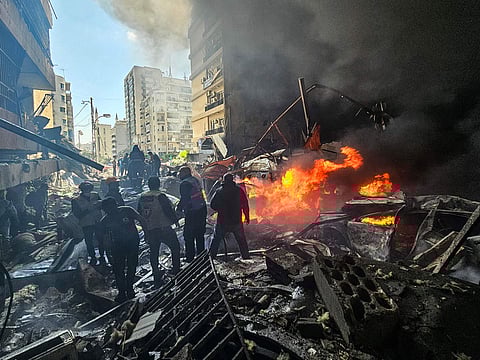 First responders stand amid rubble at the site of an Israeli airstrike in Beirut's Corniche Al Mazraa neighbourhood on April 8, 2026