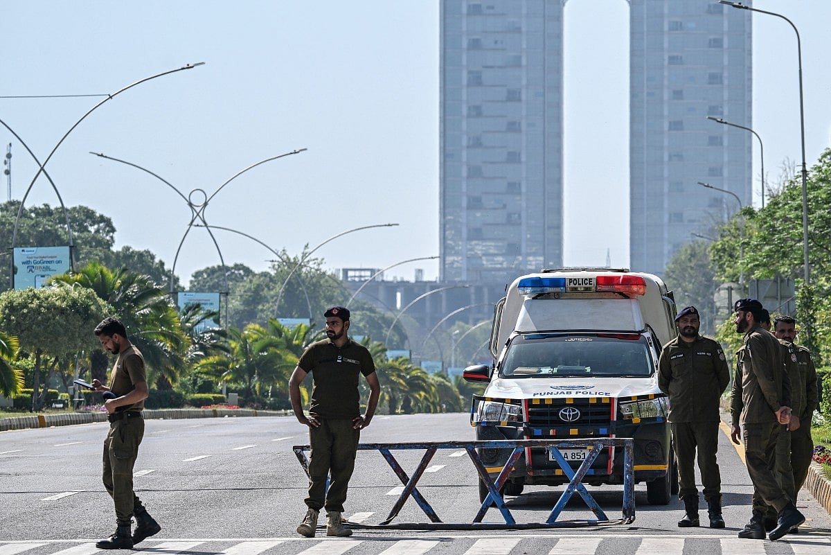 Security personnel keep watch along the cordon street near the expected venue of the US-Iran talks in the Red Zone area of Islamabad on April 10, 2026.