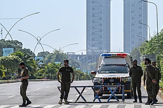 Security personnel keep watch along the cordon street near the expected venue of the US-Iran talks in the Red Zone area of Islamabad on April 10, 2026.